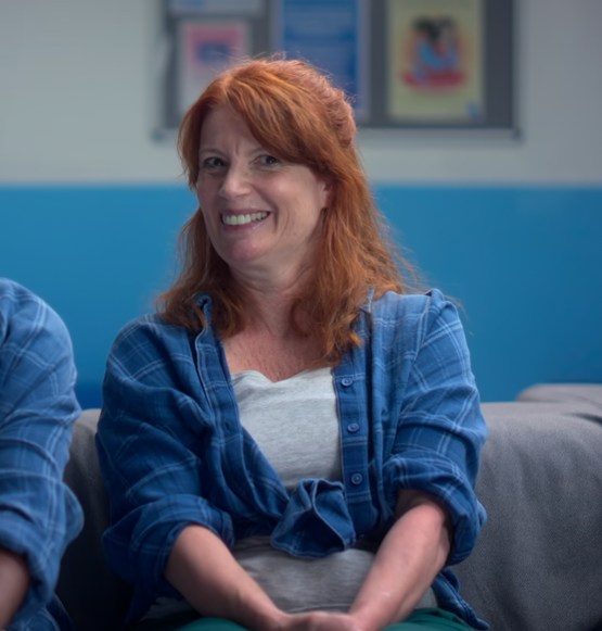red haired woman in blue shirt