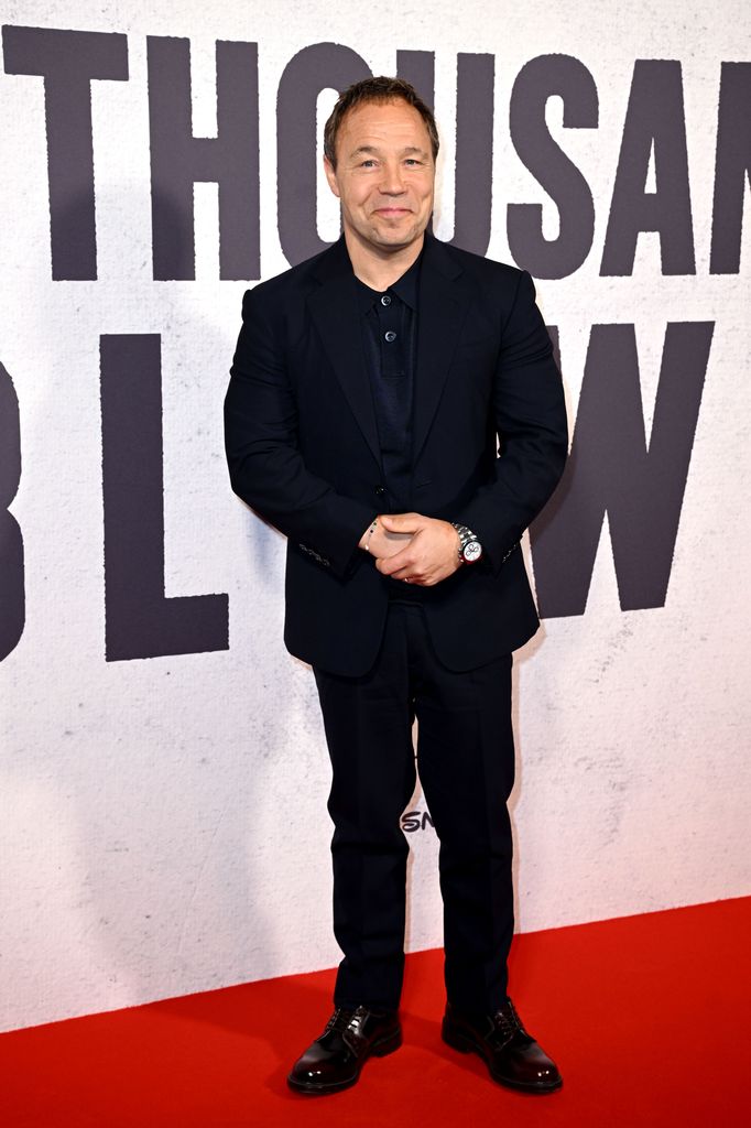 Stephen Graham in a black suit