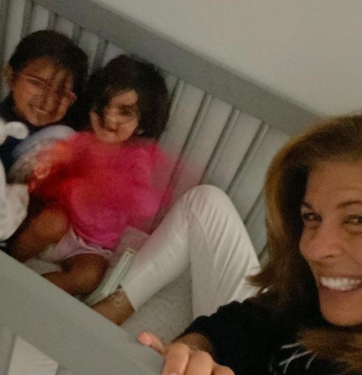 hoda kotb smiles with her daughters in their crib