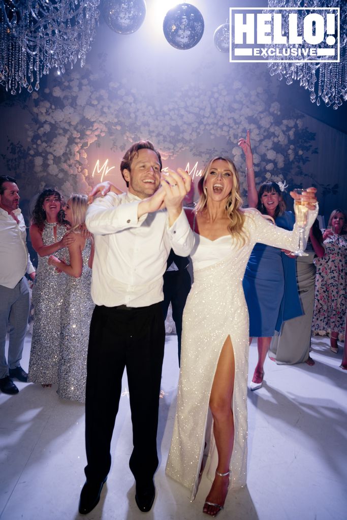 Olly Murs claps next to wife Amelia in a sparkly wedding dress at their reception