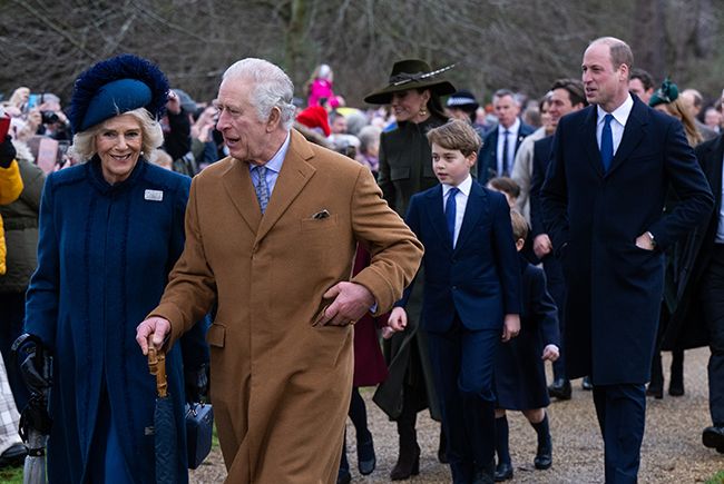 King Charles walking with Camilla with Prince George behind them