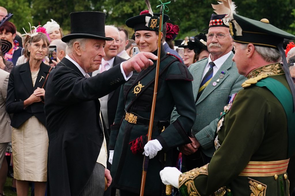King Charles III stands with Lady Katherine Douglas (C) of the Royal Company of Archers