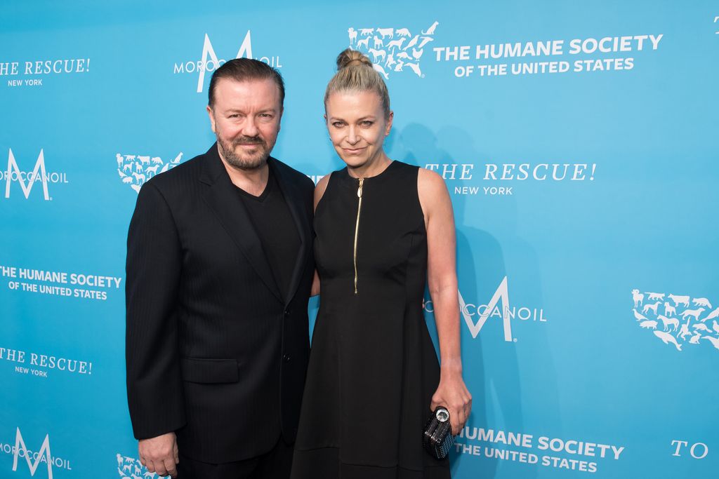 Ricky Gervais and Jane Fallon with blue backdrop
