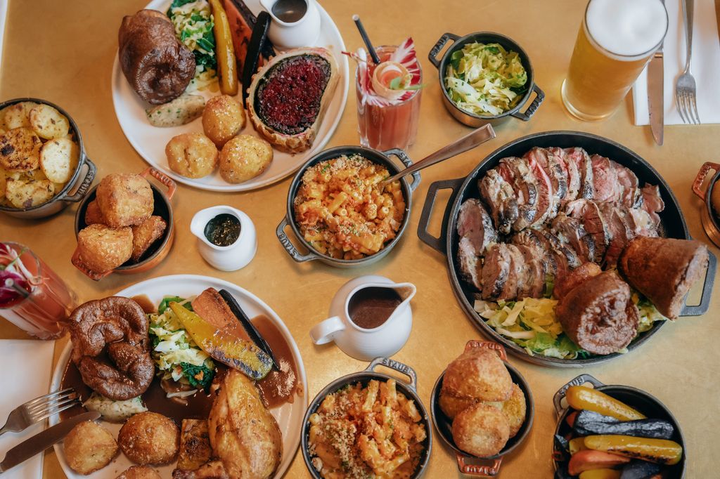 A table full of Sunday Roast dinners and sides