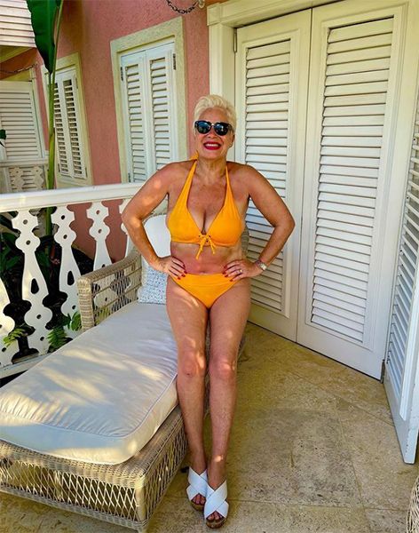 Denise Welch shows off her incredible figure in a vibrant green swimsuit in  Dubai