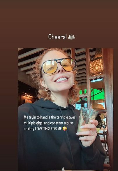 Stacey Dooley smiling in sunglasses and a hoodie