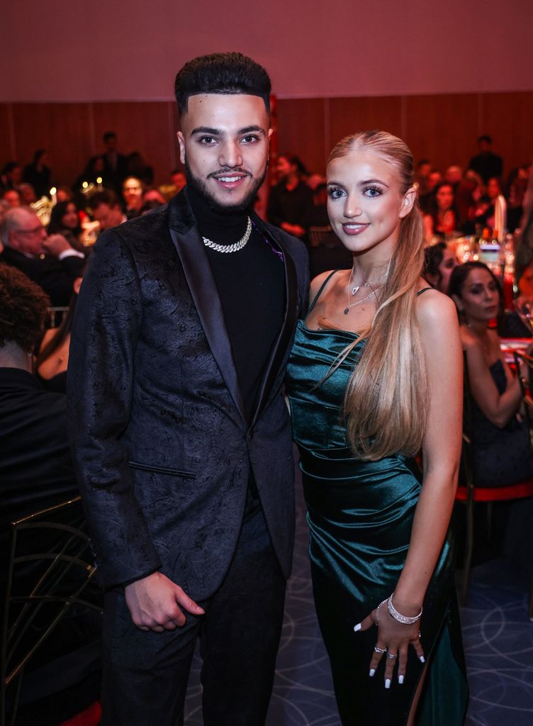 sibling duo posing at glam ball