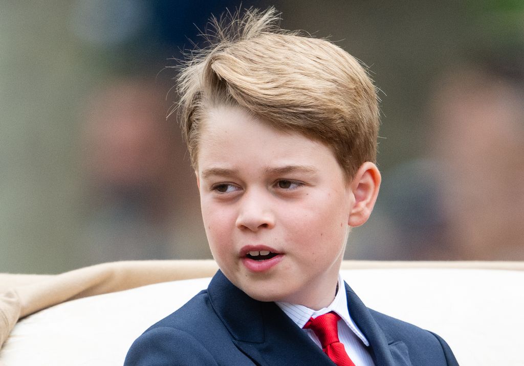 Prince George in a suit and red tie  during Trooping the Colour 2023