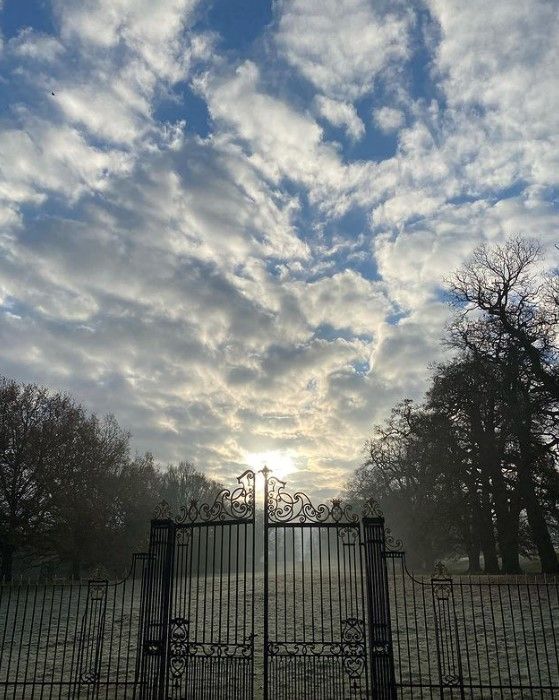 althorp house gates with mist and clouds above