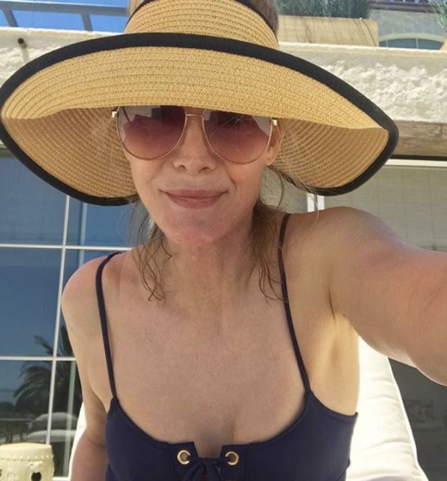 Michelle Pfeiffer posing in a swimsuit in the garden of her new pacific palisades home 