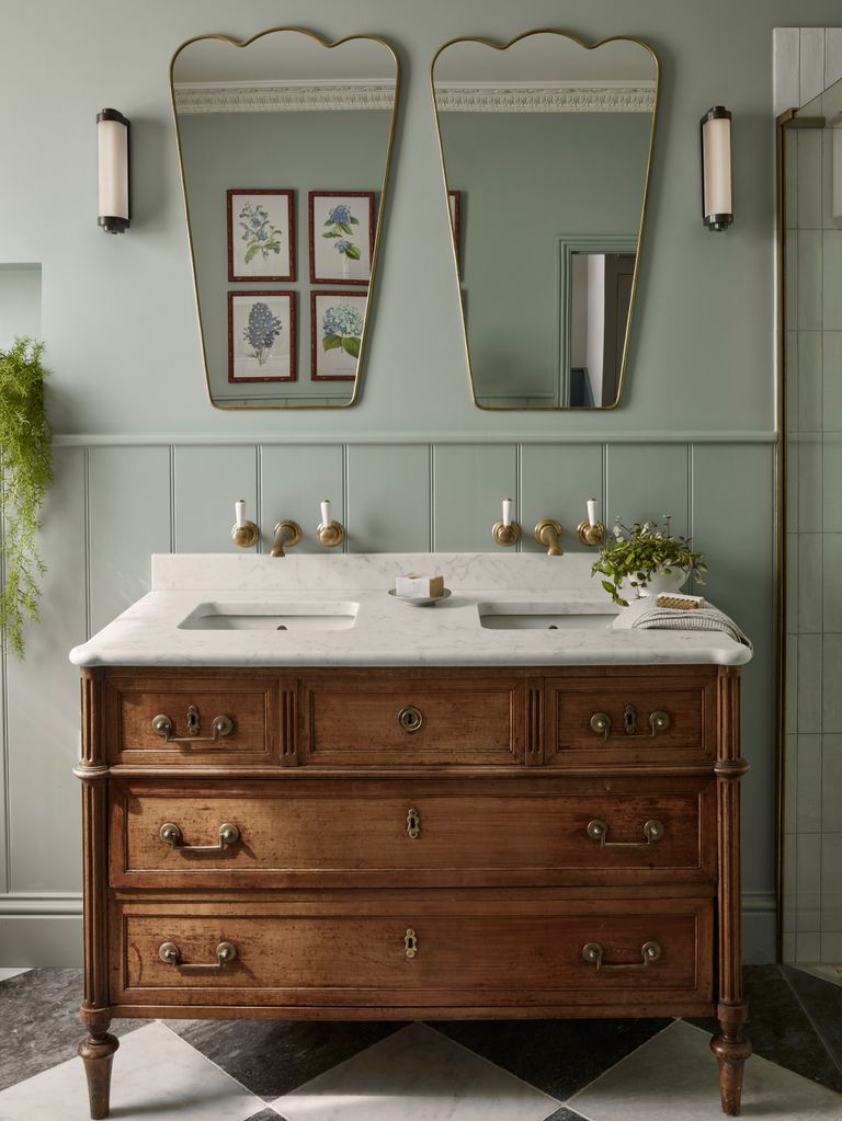 Sage green bathroom with wooden vanity unit