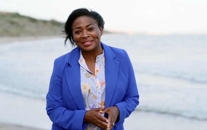 TV presenter in front of the sea