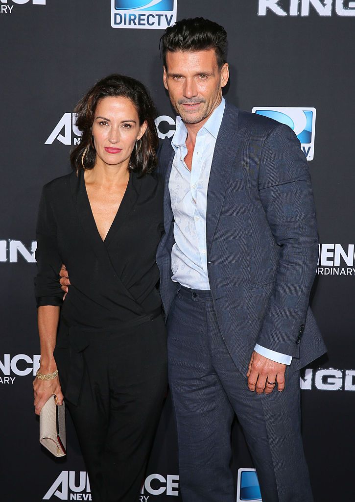 Actress Wendy Moniz and actor Frank Grillo attend the Premiere Event for DIRECTV's KINGDOM on October 1, 2014. She is wearing a black dress while he is wearing a navy suit. 