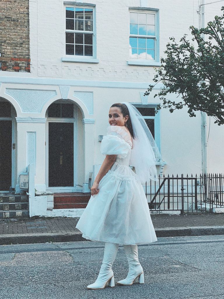 Laurie wearing a short wedding dress in the street in London