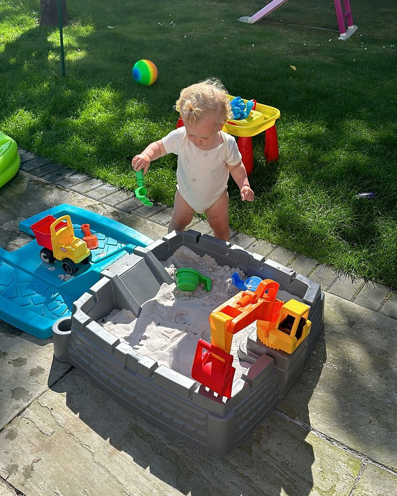 young boy playing in sandpit 