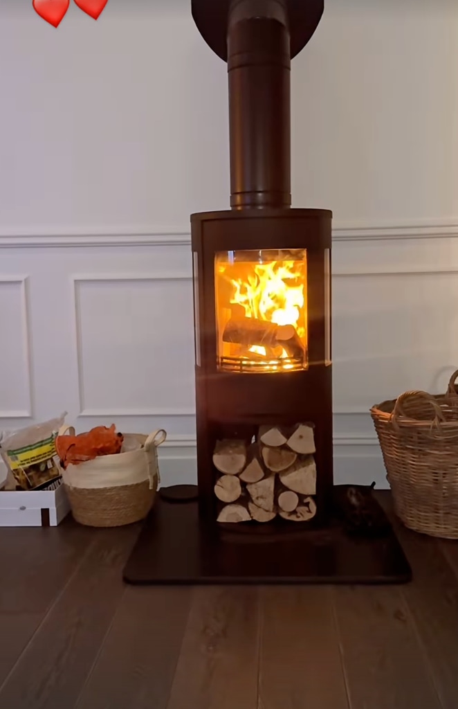 Dianne shows off their new wood-burning fireplace