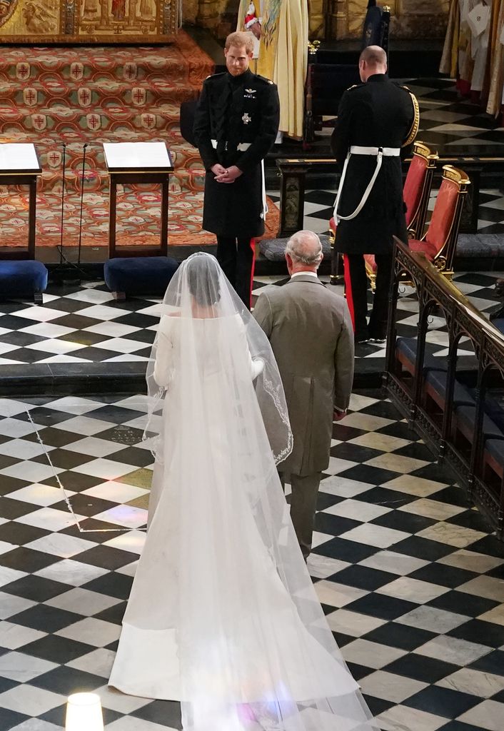 Prince Harry looks at his bride Meghan Markle as she walks down the aisle on their wedding day