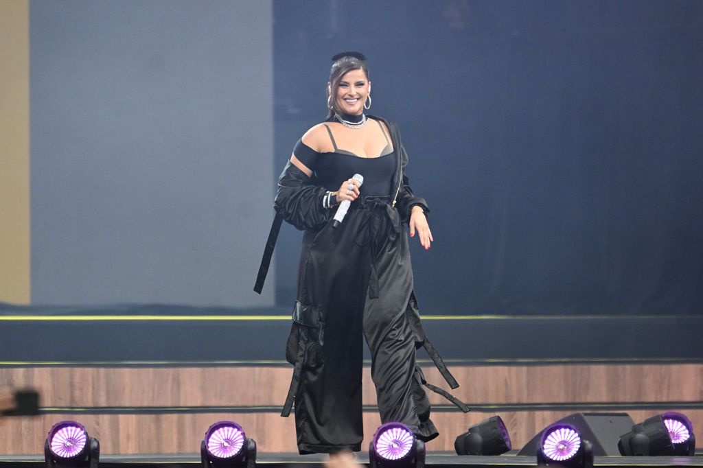 Nelly Furtado performing in a black outfit