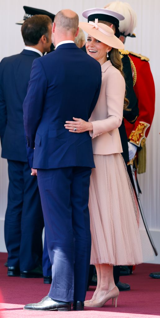 Kate with her arm around William's waist