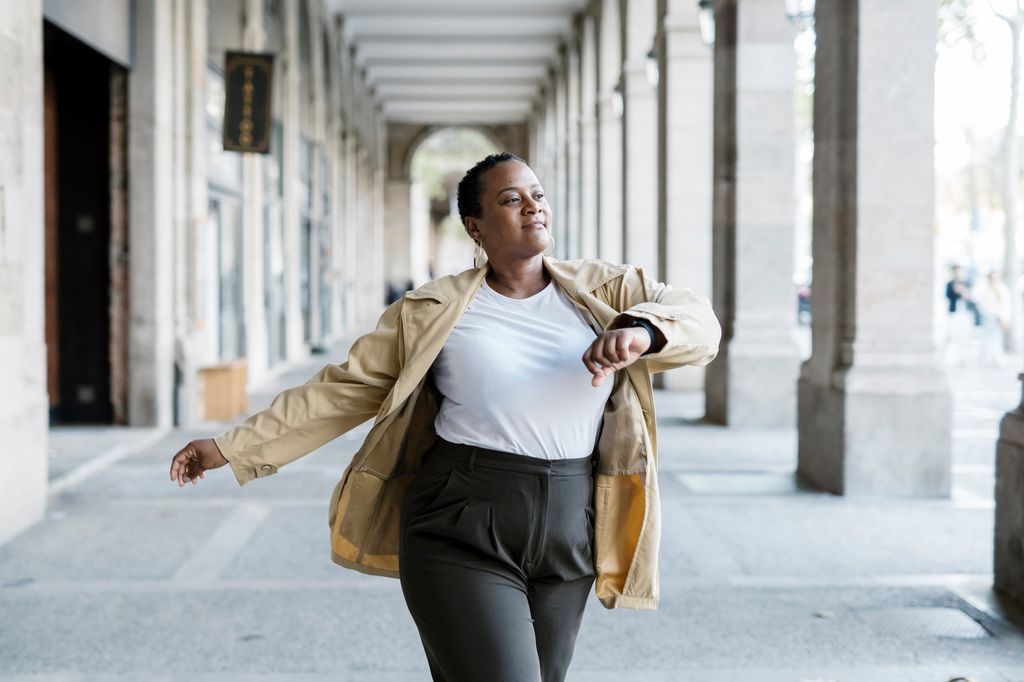 woman walking through arches