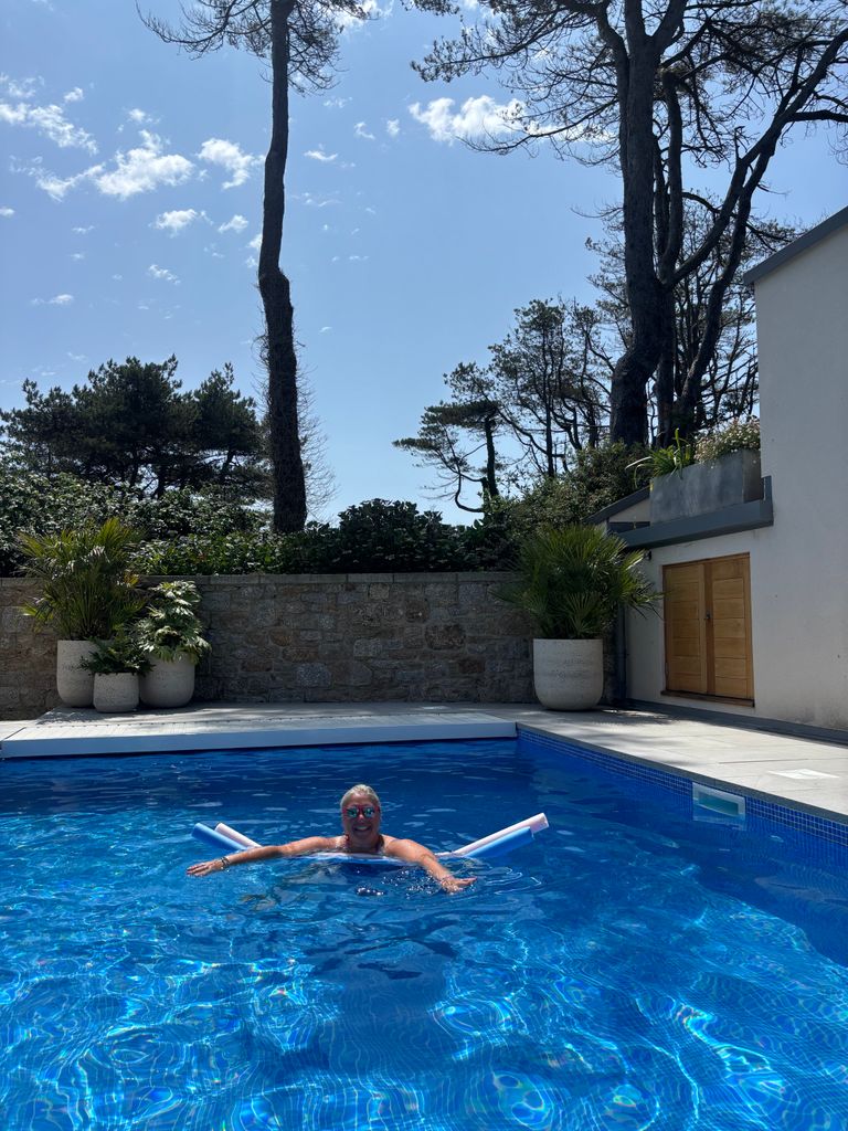 Woman on a pool noodle in a swimming pool