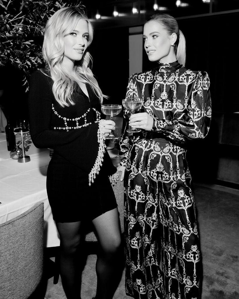 Lady Eliza and Lady Amelia Spencer smiling holiding drinks