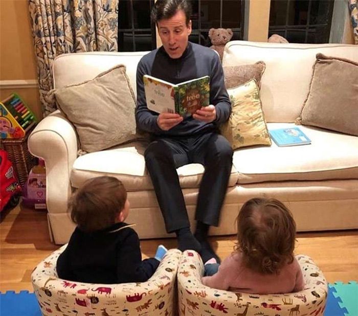 anton du beke reading to twins in lounge