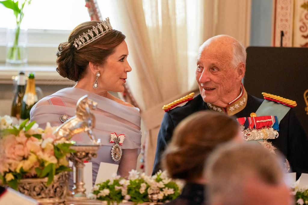 King Harald V of Norway (R) and Queen Mary of Denmark speak during a gala dinner