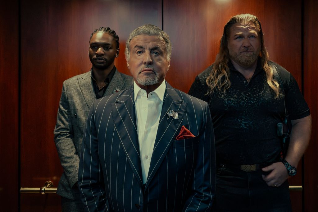 three men standing in elevator