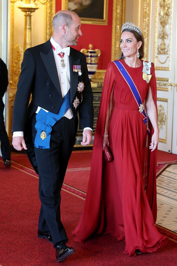 Kate smiling at William in red evening dress