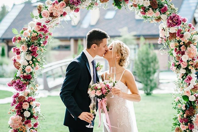 bride and groom flower arch