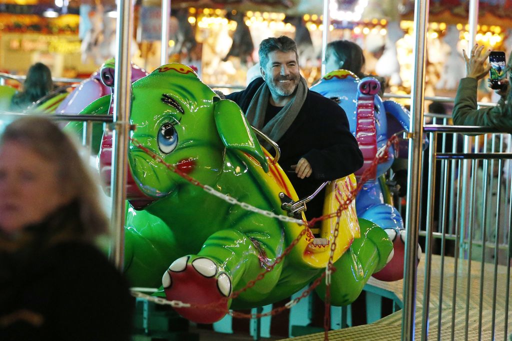 Simon Cowell riding green elephant at Winter Wonderland VIP Launch