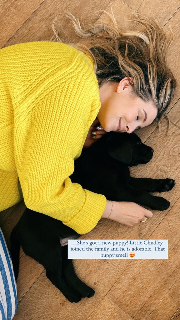 A photo of Zoe Sugg cuddling a puppy 