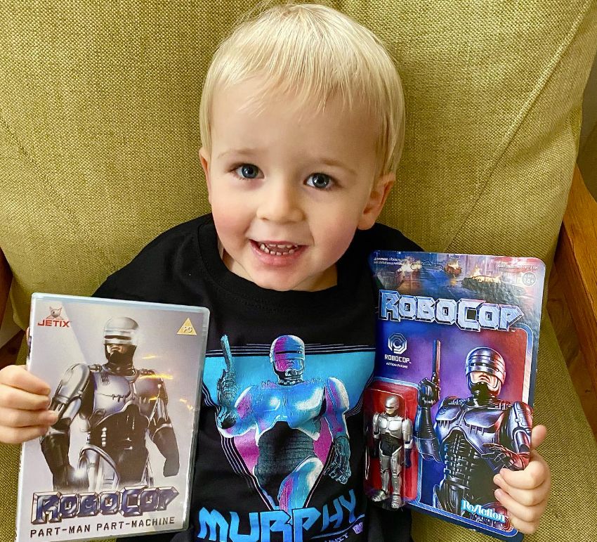 A young blonde chidl with Robocop merchandise