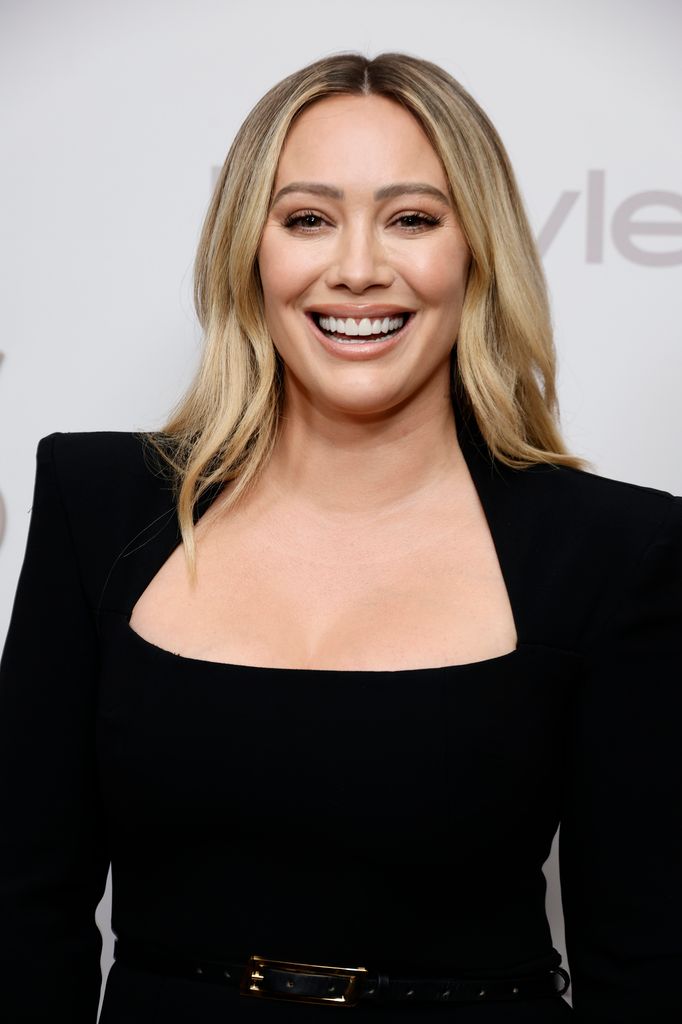 hilary duff black dress smiling