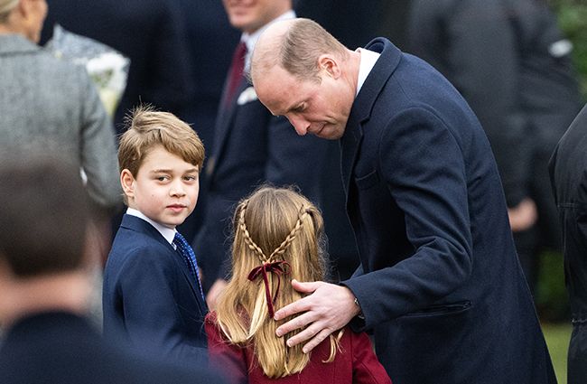 Prince William putting his arm around Princess Charlotte