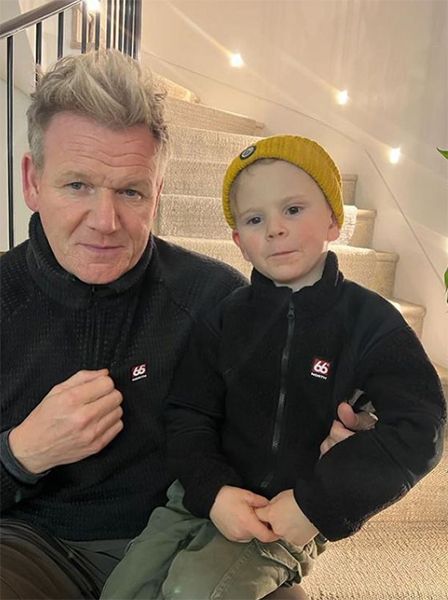 Gordon Ramsay and son sat on stairs