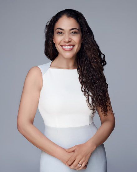 woman smiling in white top