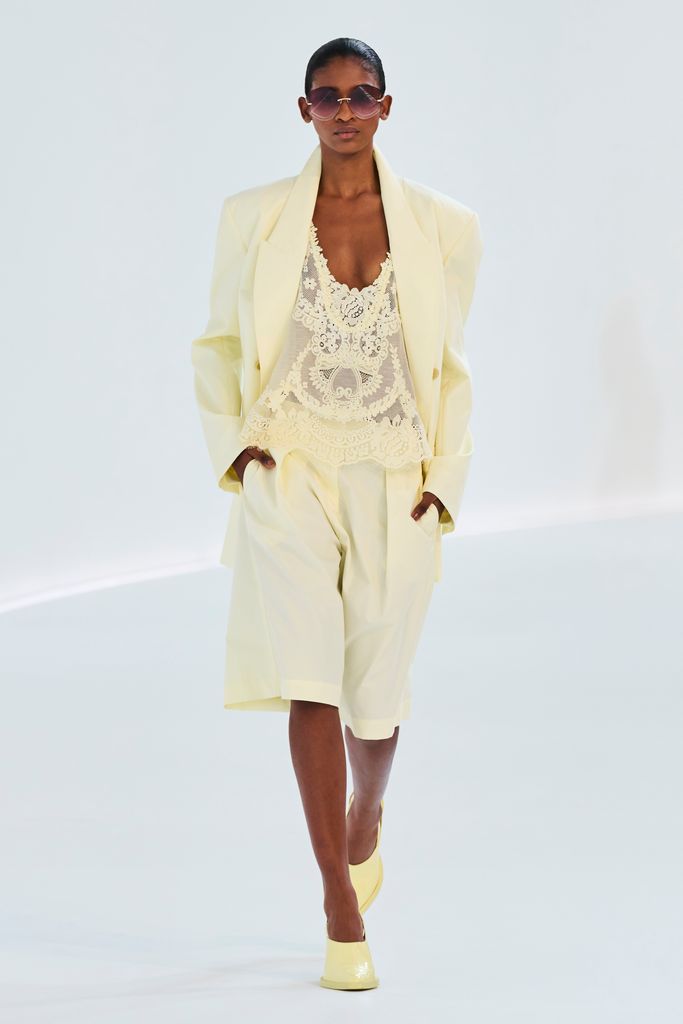 A model wears cream knee length shorts and matching blazer at Zimmermann SS24