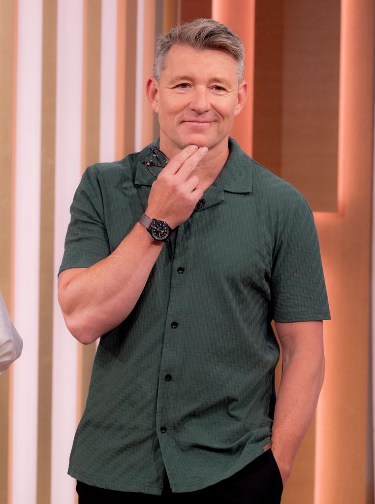 Ben Shephard in a green shirt and trousers