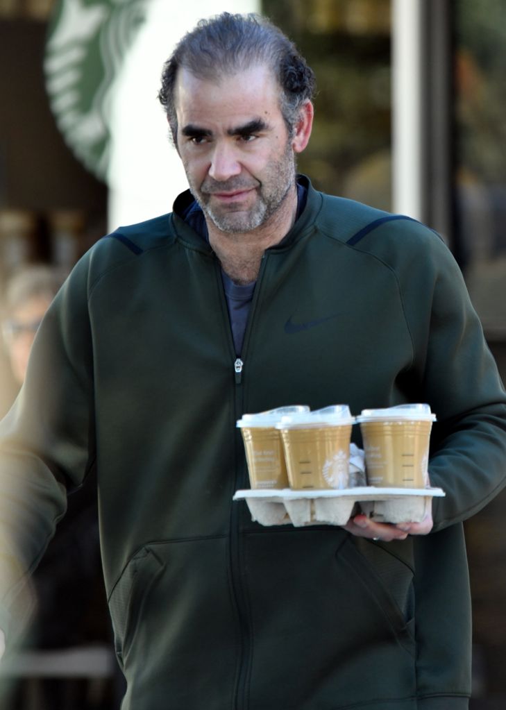 man holding tray of coffees 