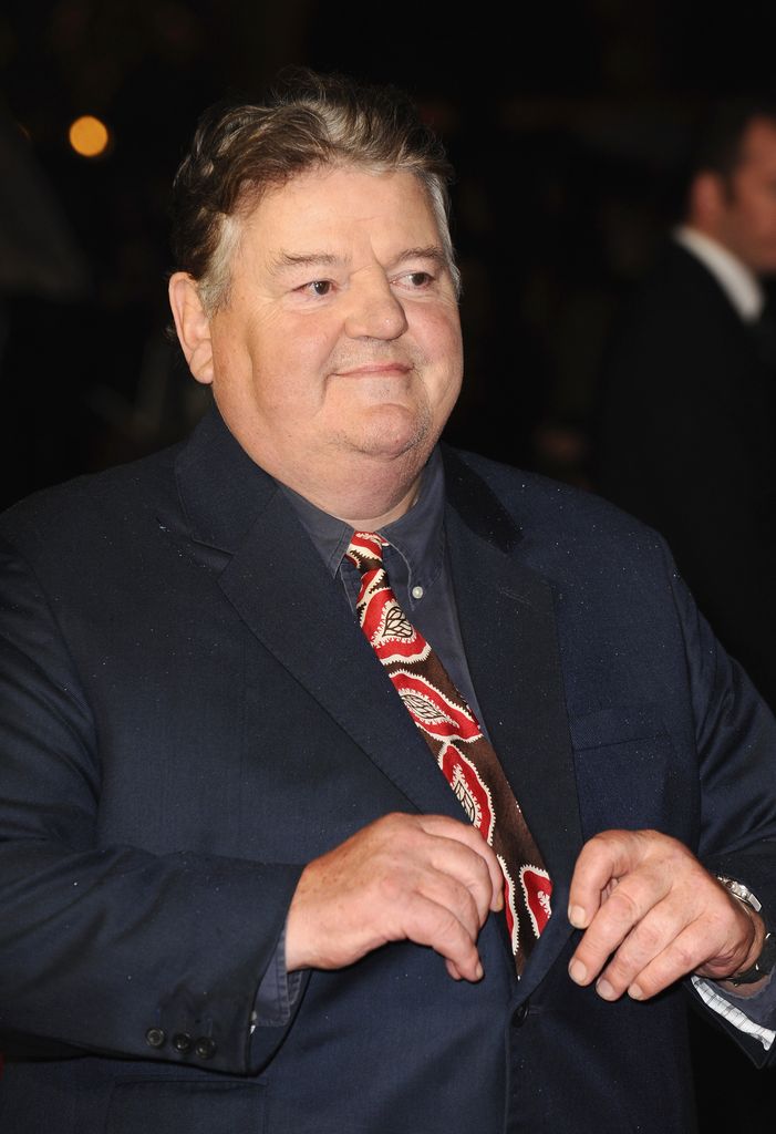 Robbie Coltrane wearing a blue suit