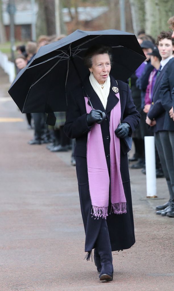 Princess Anne was pictured in a purple scarf, perhaps a nod to the school colours