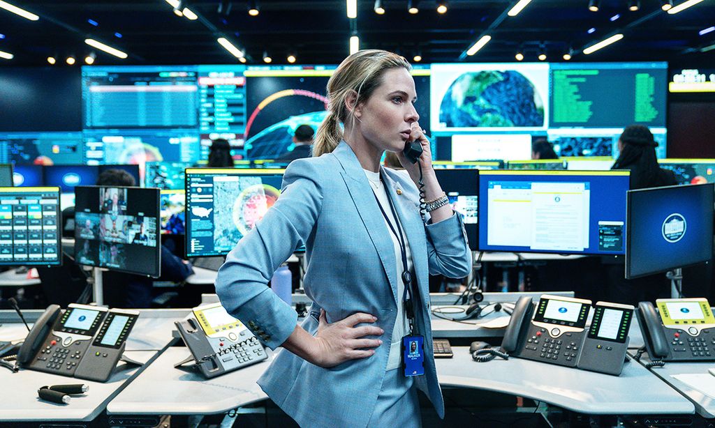 woman in blue sit on phone