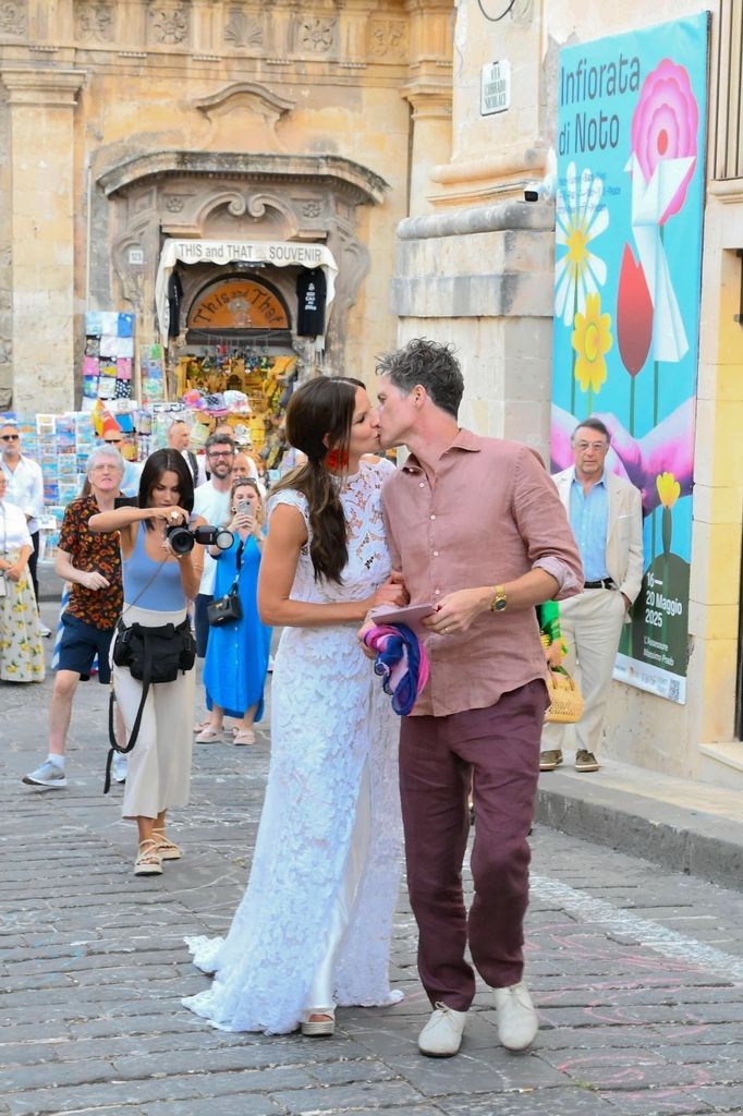 Fuschia Kate Sumner kissing husband on street