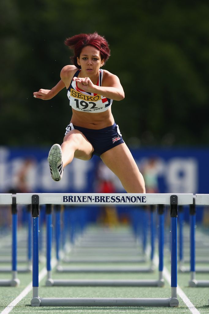 Katarina Johnson-Thompson jumping over a hurdle