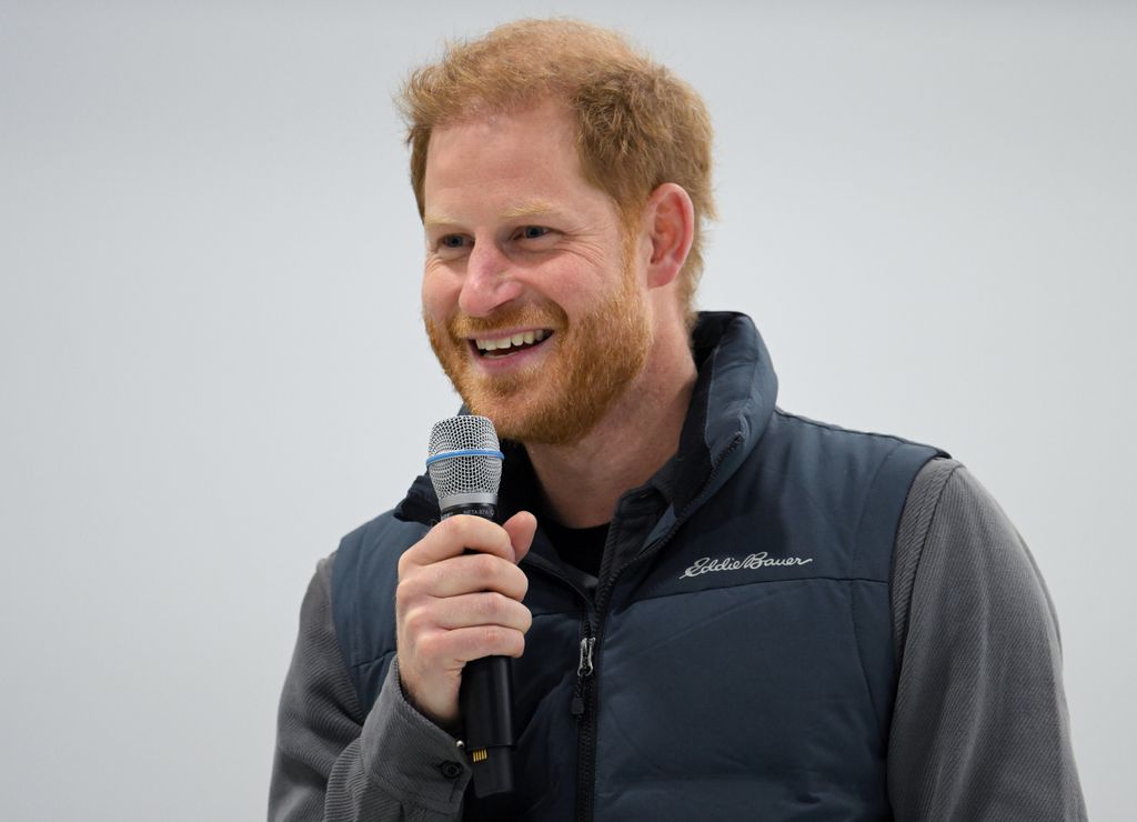 Prince Harry holding a microphone during his speech