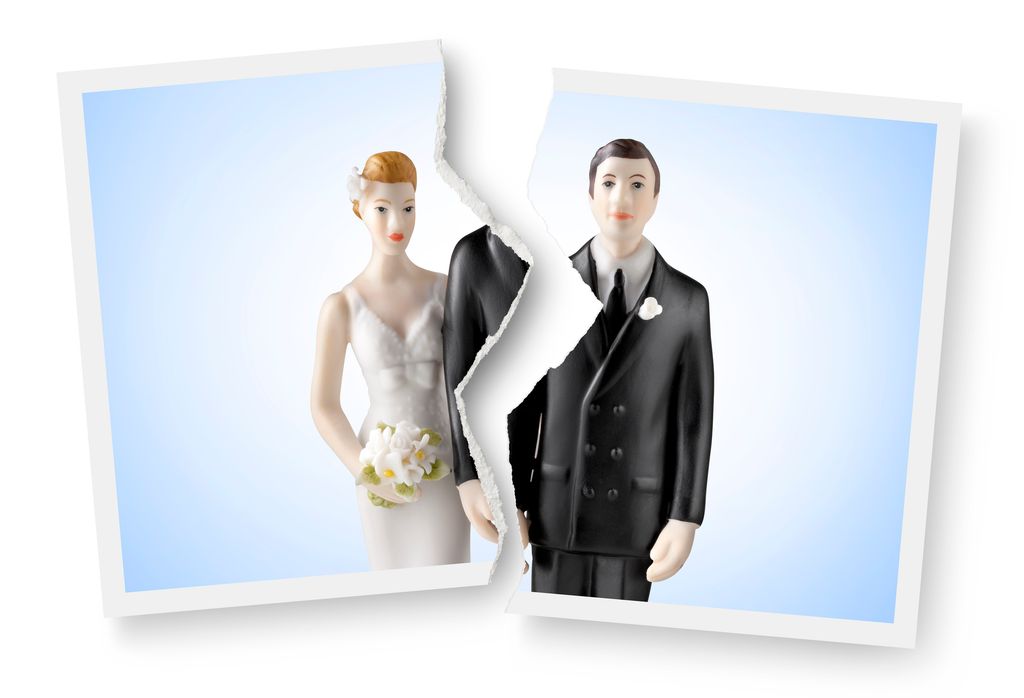 Divorce image Torn photograph of wedding cake topper