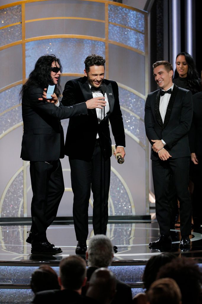 In this handout photo provided by NBCUniversal,  James Franco, with Tommy Wiseau and Dave Franco,  accepts the award for Best Performance by an Actor in a Motion Picture â Musical or Comedy for  âThe Disaster Artistâ during the 75th Annual Golden Globe Awards at The Beverly Hilton Hotel on January 7, 2018 in Beverly Hills, California.