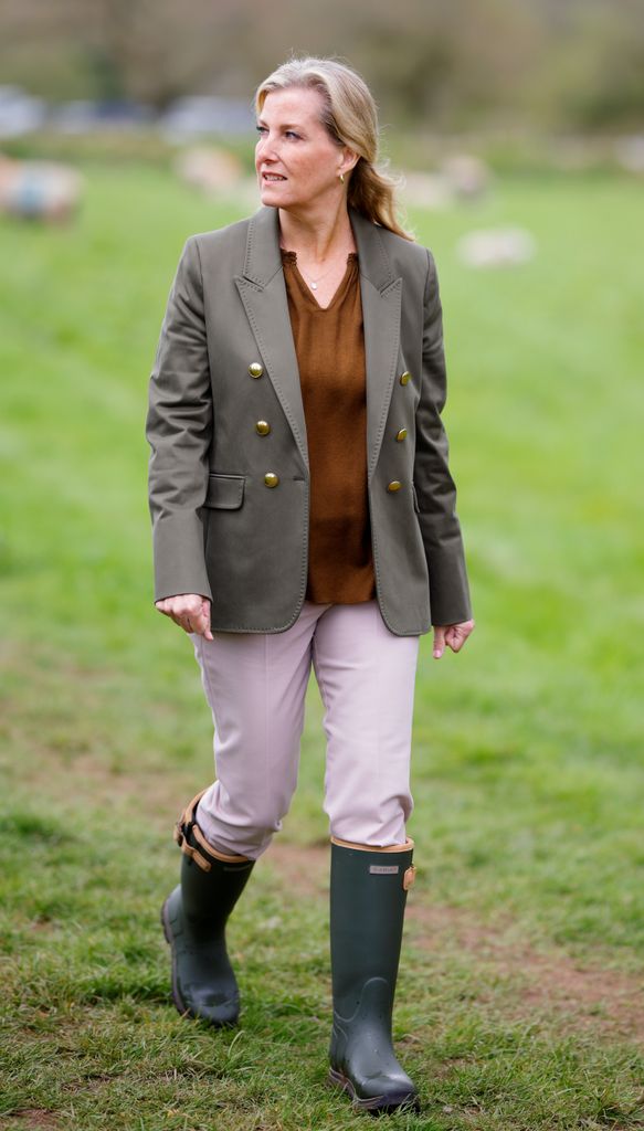 Sophie in blazer and wellies in field